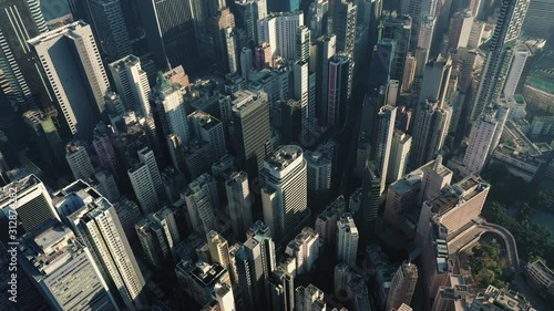 AERIAL. Cinematic video and Top view of Hong Kong city center at sunset and sun light. photo