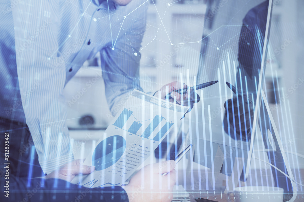 Double exposure of chart with businessman typing on computer in office on background. Concept of hard work. Double exposure of chart with businessman typing on computer in office on background. Concept of hard work.
