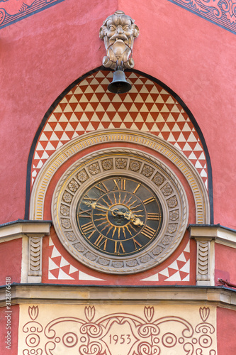 Clock on the Simonettich tenement house on the corner of the old town square, Warsaw, Poland photo