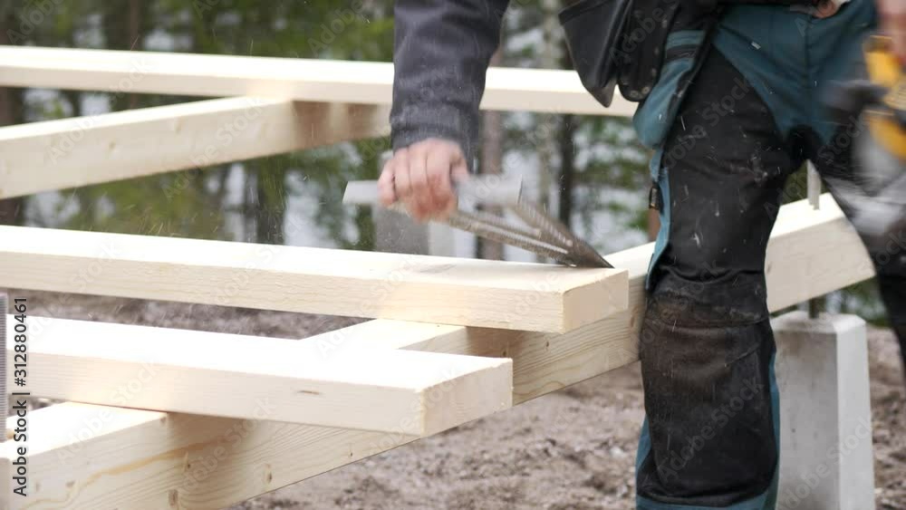 Contractor craftsman using circular saw at construction site, slow motion shot Contractor craftsman using circular saw at construction site, slow motion shot