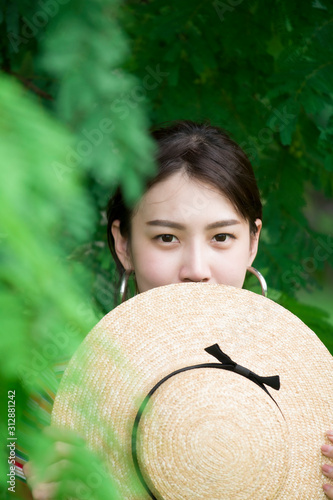 Portrait of young Asian woman is enjoy lifestyle traveling at the park during summer.