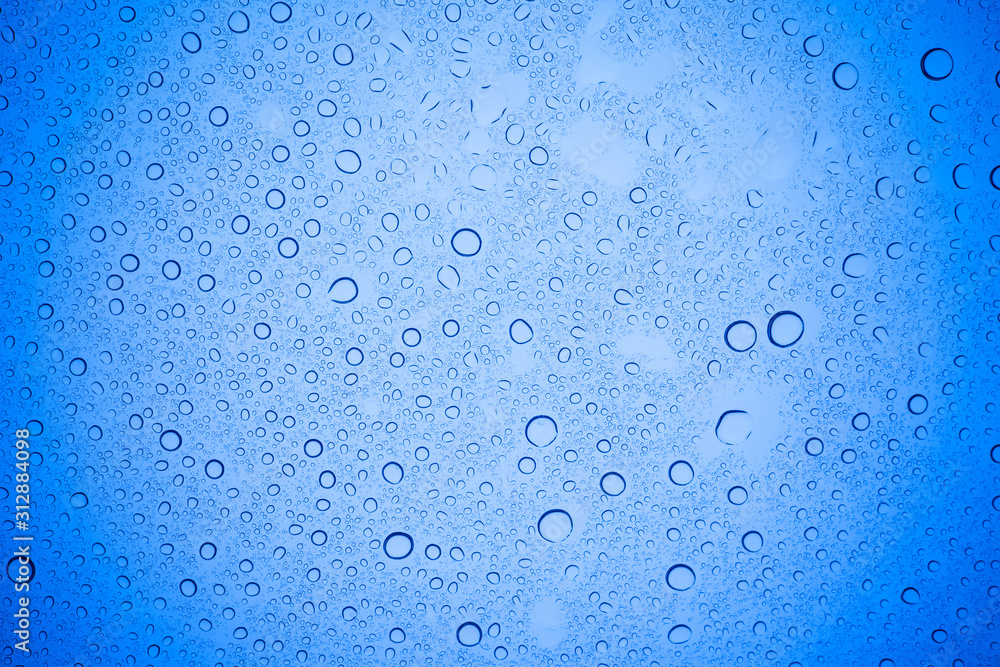 Rain droplets on blue glass background, Water drops on blue glass. Rain droplets on blue glass background, Water drops on blue glass.
