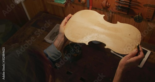 Female luthier at work in her workshop photo