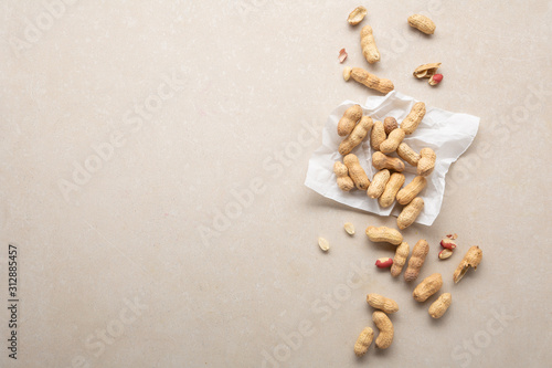 Bunch of peanuts on white paper, heathy food and copy space