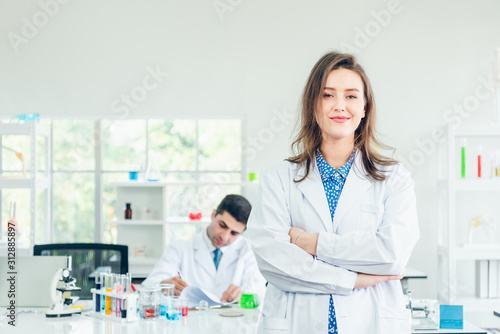Portrait of young asian doctor isolated on lab background