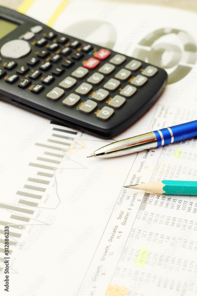Business concept with a report and a calculator Business concept with a report and a calculator
