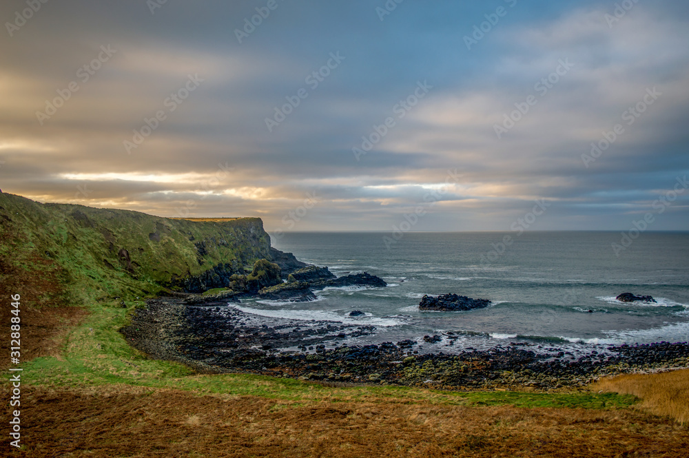 Northern Ireland Antrim Coast Ballintoy Harbour with rocks and sunset waves, beautiful scenery
