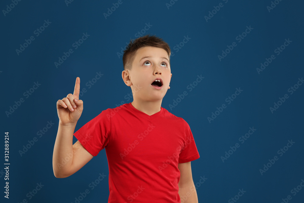 Portrait of emotional preteen boy on blue background Portrait of emotional preteen boy on blue background