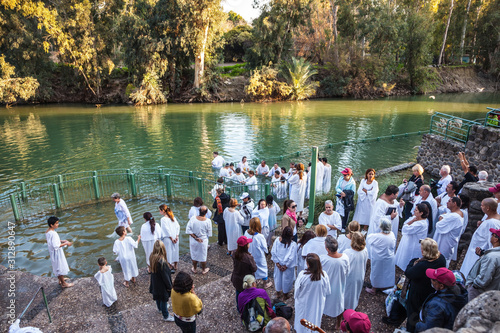 Fototapeta Christian pilgrims baptized dressed in white shirt