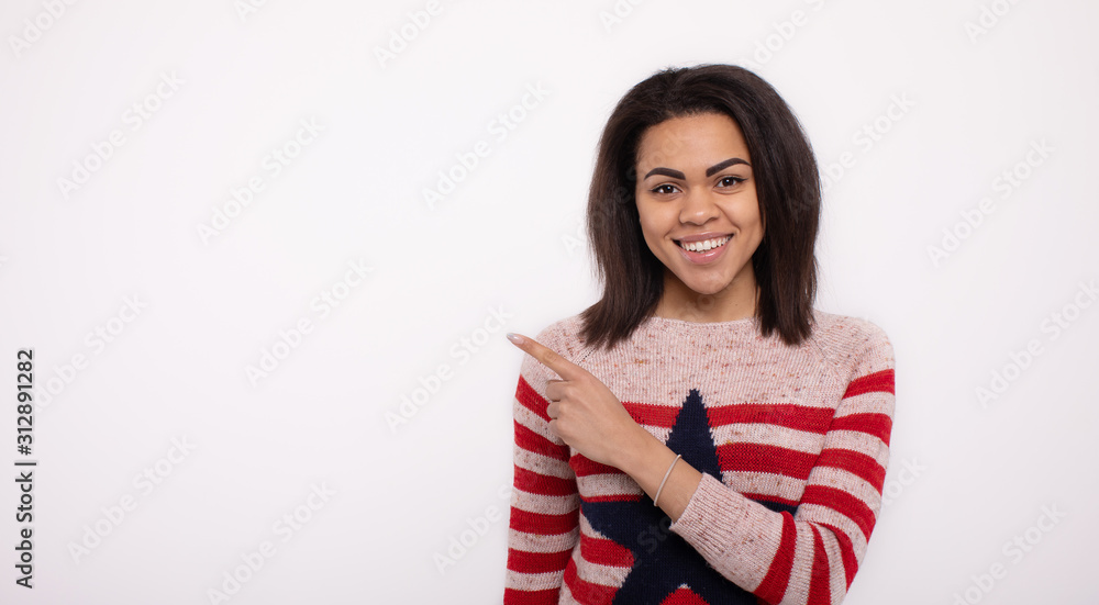 Portrait of beautiful calm young african american presenting by pointing hand on side. Portrait of beautiful calm young african american presenting by pointing hand on side.