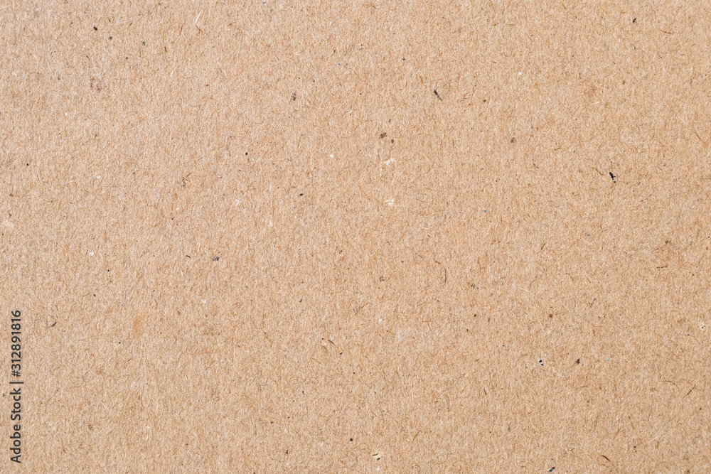 Light brown wrapping paper. Natural sheet surface, packaging background. Texture of cardboard, pasteboard, stiff paper. Light brown wrapping paper. Natural sheet surface, packaging background. Texture of cardboard, pasteboard, stiff paper.