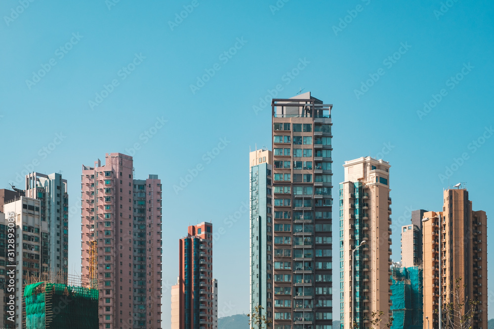 Obraz premium residential skyscraper buildings, skyline and blue sky in Hong Kong -