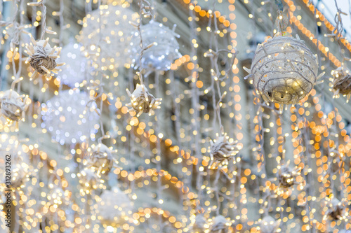 Street decorated with festive garlands during winter holidays photo