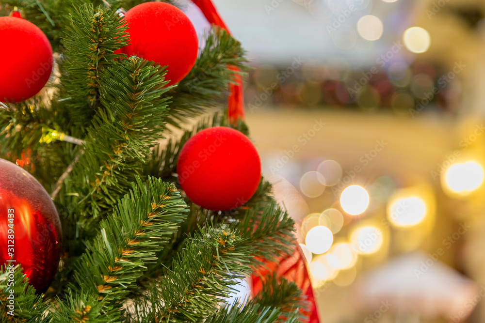 Decorated Christmas tree on defocused dreamy bokeh background, closeup with space for copy
