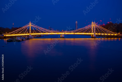 Long exposure, illuminated Albert bridge in London at night