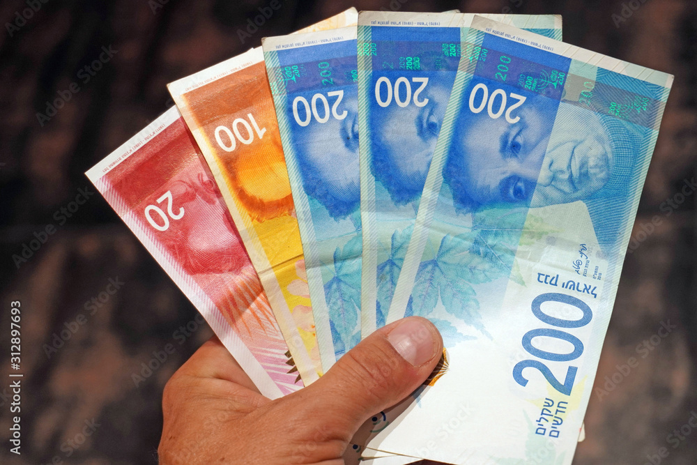 Pile of NIS - New Israeli Shekels banknotes with the new 200, 100, 20, 50 sheqel. Wallpaper of shekels bills -Top View. Politics and money of Israel background