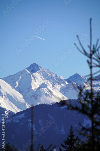 beautiful winter landscape in the alps with fresh snow on a sunny day with clear blue sky