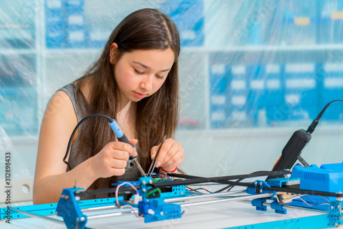 Photography Schoolgirl in the classroom design and development of robots