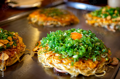 Bild auf Leinwand Okonomiyaki, Hiroshima food with egg Japan