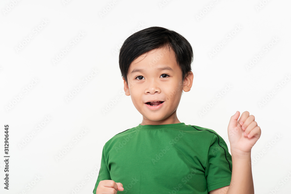 Portrait of cute smart young Asian boy shows winning gesture and smiling at camera, celebrating success victory against white background Portrait of cute smart young Asian boy shows winning gesture and smiling at camera, celebrating success victory against white background
