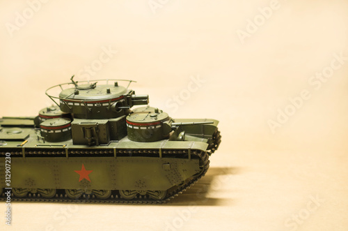 The scale model of a heavy tank T-35 at the paper background. The war and weapon concept with copyspace for text.