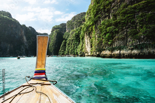 Beautiful sunny bay in Thailand. Ko Phi Phi island one day tour. Tropical exotic holiday landscape. Long tail wooden boat ride over sea water. © Paweł Michałowski