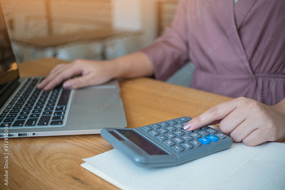 Business women checking bills. taxes bank account balance and calculating annual financial statements of company. Accounting Audit Concept Business women checking bills. taxes bank account balance and calculating annual financial statements of company. Accounting Audit Concept