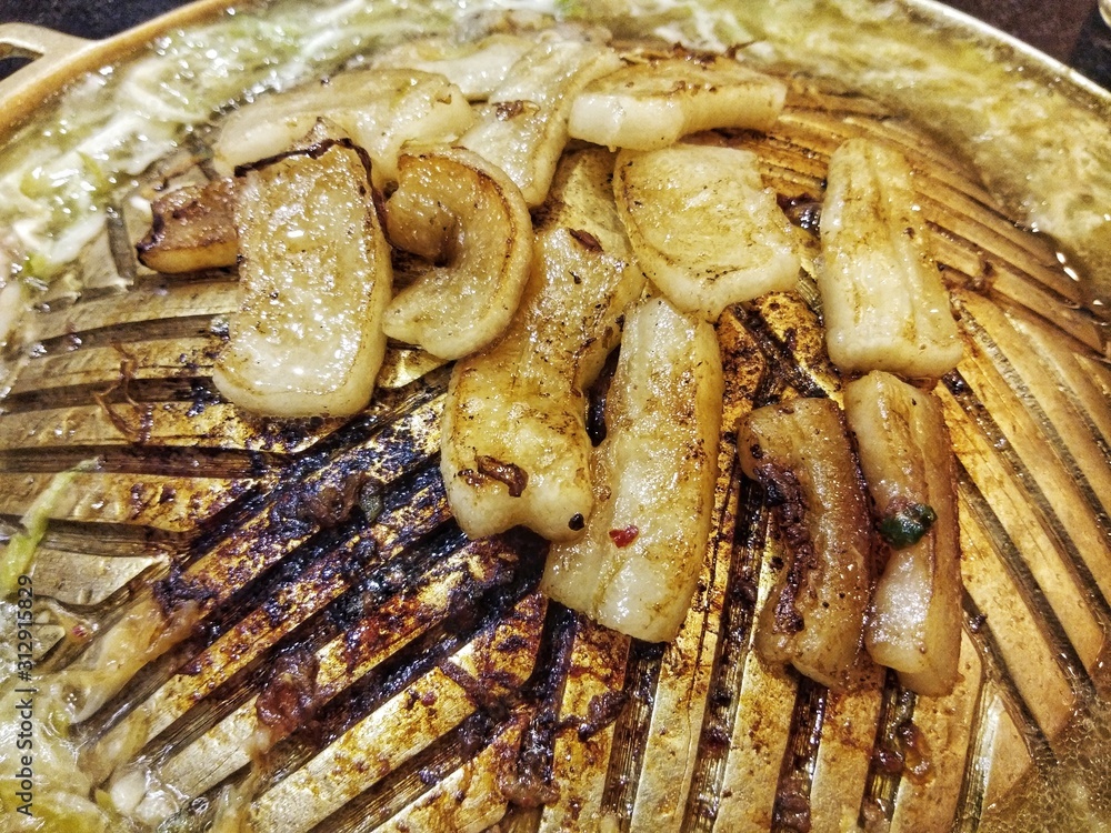 Pork lard on the barbecue pan - unhealthy food