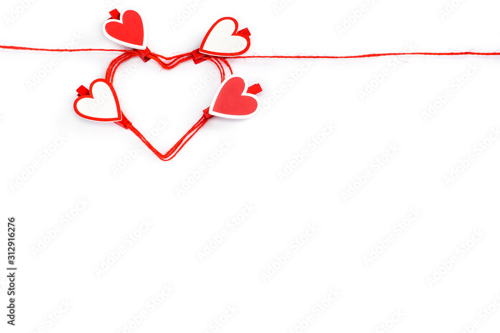 rolled in heart shape red rope with clothespins in shape of hearts isolated on white background. Valentine's Day concept. Greeting card with copy space for your text or advertising