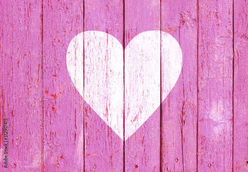 Old wooden board background with cracked pink paint and white heart shape