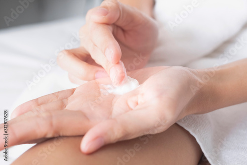 Woman applying moisturizing cream/lotion on hands, beauty concept.. © BoszyArtis