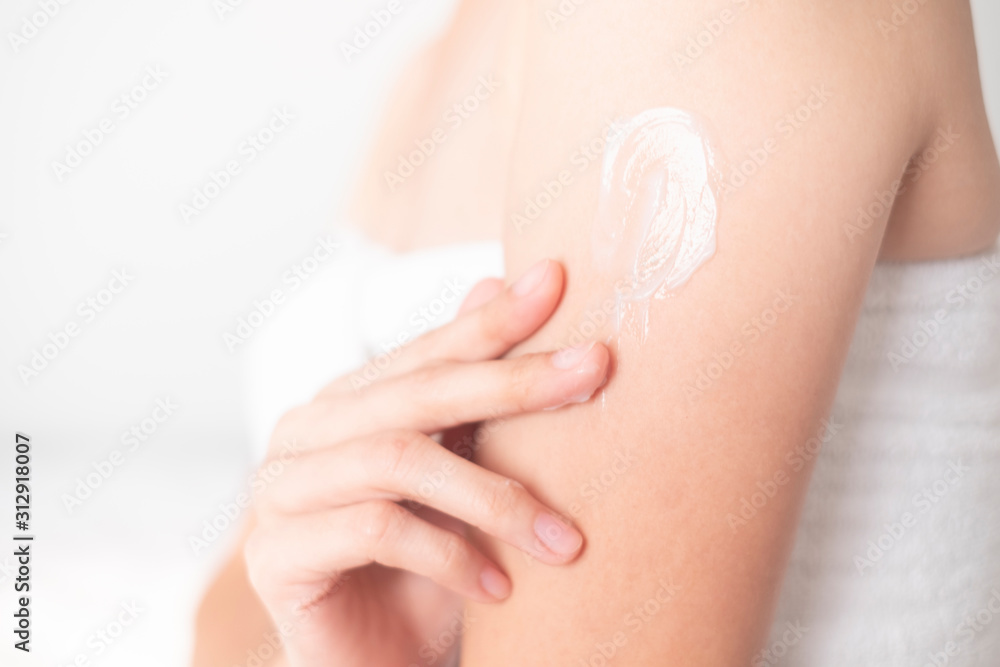 Naklejka premium Woman applying arm cream,lotion , Hygiene skin body care concept..