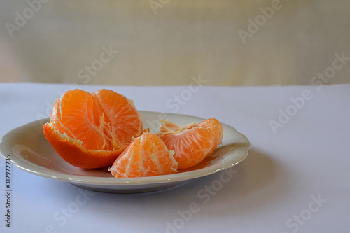 Purified mandarin on the light surface of the table.