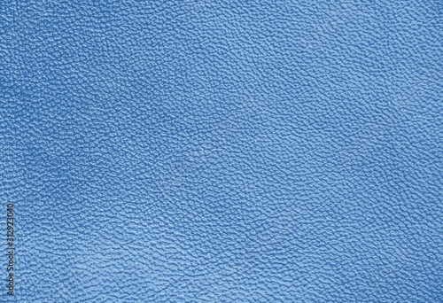 Genuine Leather. Blue background. The texture of the skin close-up.