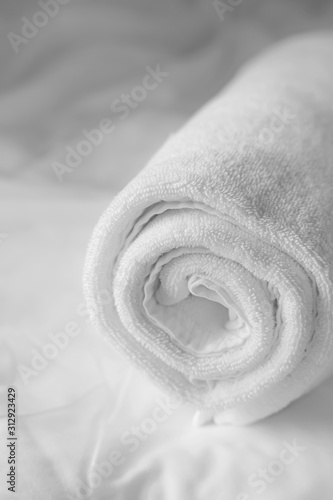 white towel on white bedsheet
