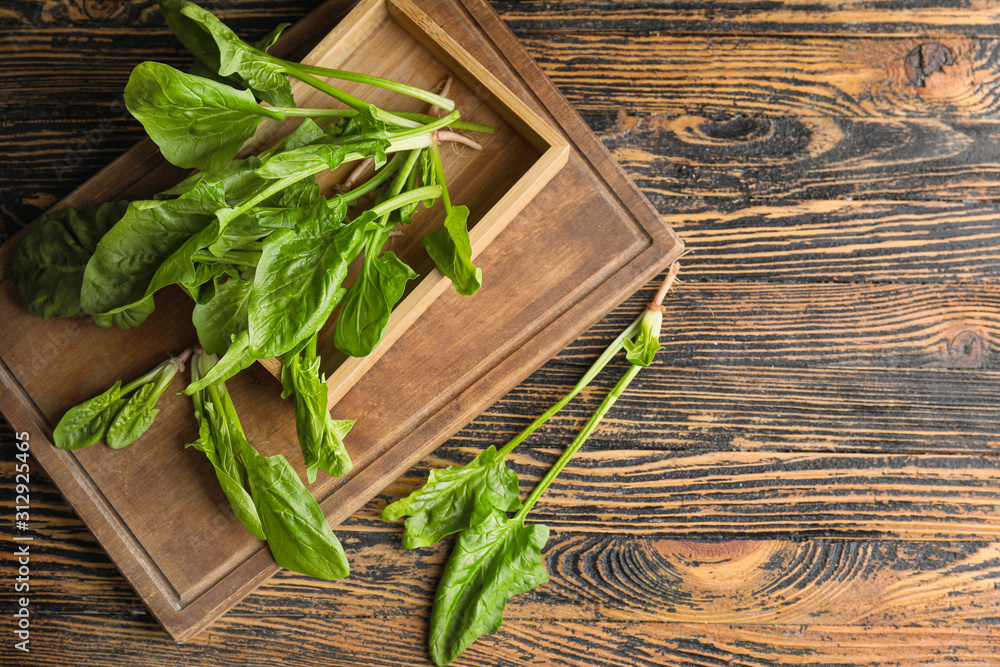 Fresh green spinach on wooden table