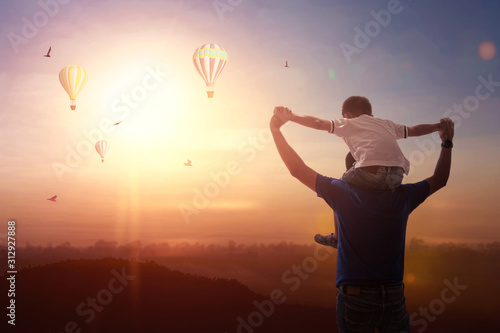Son riding back father with outdoors on background sunset. Father holiday. new year concept