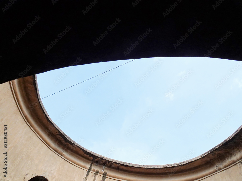 Fototapeta premium Blue sky view in the void of Sumur Gumuling building in Taman Sari area