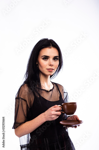 Young brunette girl with a cup of coffee on white background
