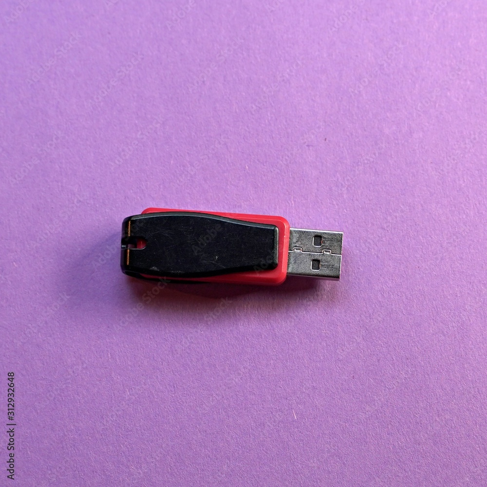 red and black Usb flash memory on purple background , Front view red and black Usb flash memory on purple background , Front view