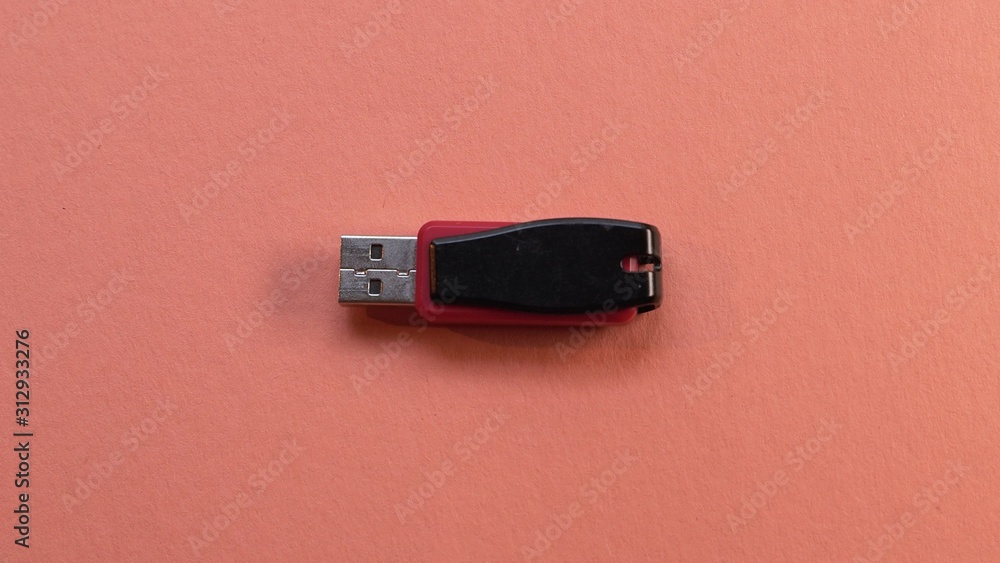 red and black Usb flash memory on orange background , Front view red and black Usb flash memory on orange background , Front view