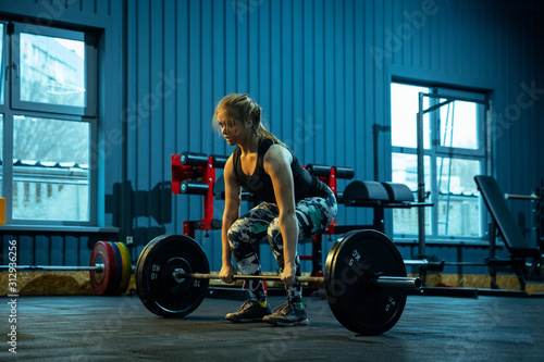 Photography Caucasian teenage girl practicing in weightlifting in gym