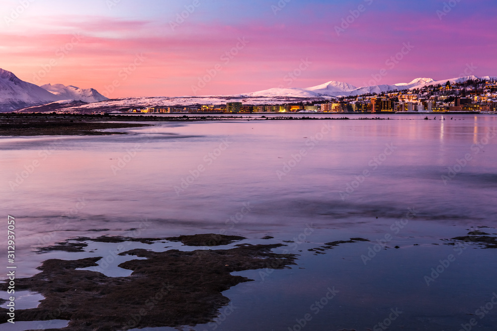 Amazing sunrise with amazing magenta color over Tromso, Norway. Polar night. long shutter speed