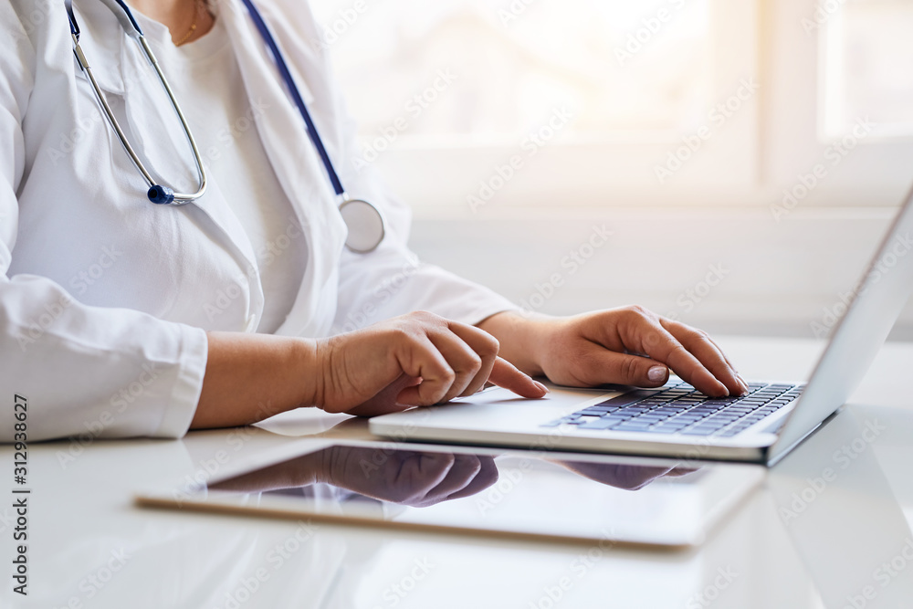 Female doctor working with her laptop in medical office Female doctor working with her laptop in medical office