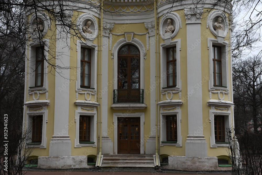 facade of an old building. yellow building façade. sculptures and decorative elements on the facade of buildings.