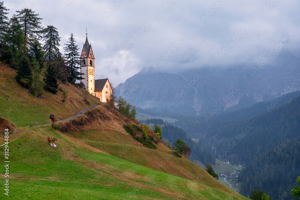 Church of Santa Barbara in the cozy little village of La Valle, Alta Badia, South Tyrol at sunset