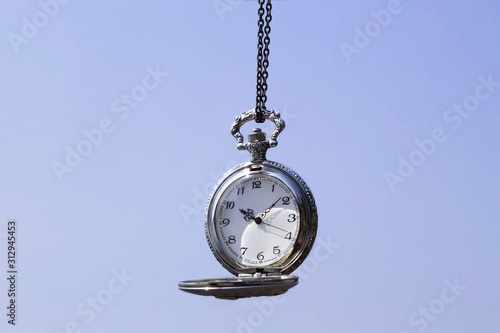 Vintage Silver Pocket Watch On Blue Isolated Background