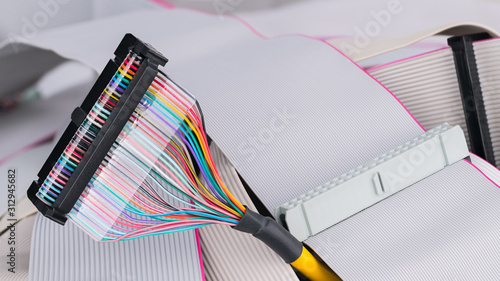 фотографія Colorful multi wire bus connector on white ribbon cables background