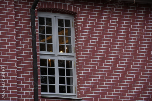 white window on a brick wall. 