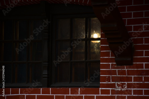 Drown wooden window. light through a wooden window. wall lamp on the wall.